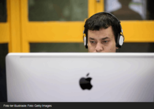 Person sitting working behind desktop