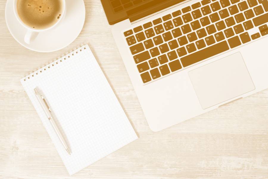 Laptop on a desk with coffee
