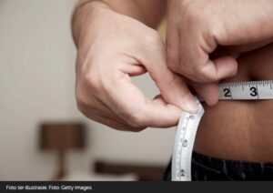 Man measuring waist